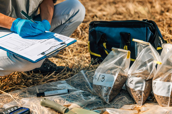 Photo of a technician performing soil tests in a field